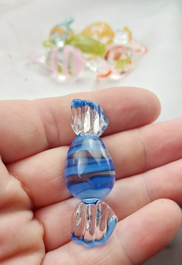 Image of hand holding a single piece of blue striped glass easter candy
