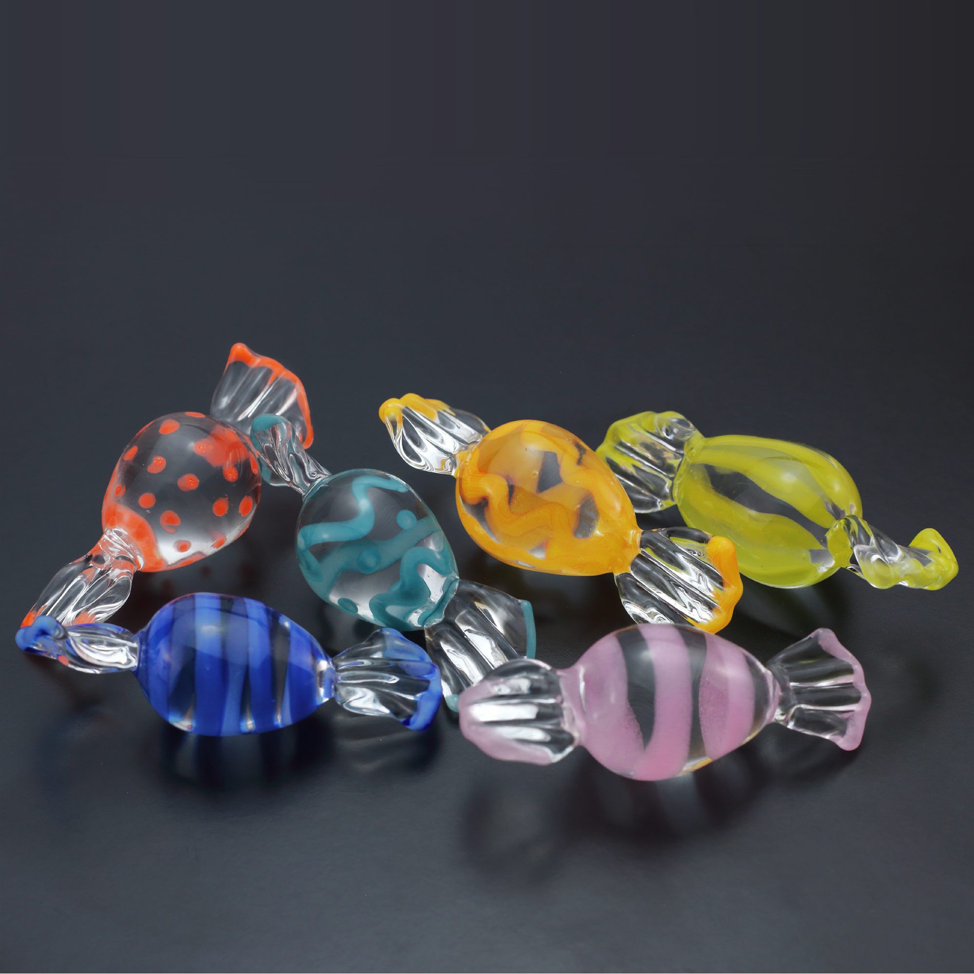 Image of 6 pieces of glass candy in the shape of easter eggs
